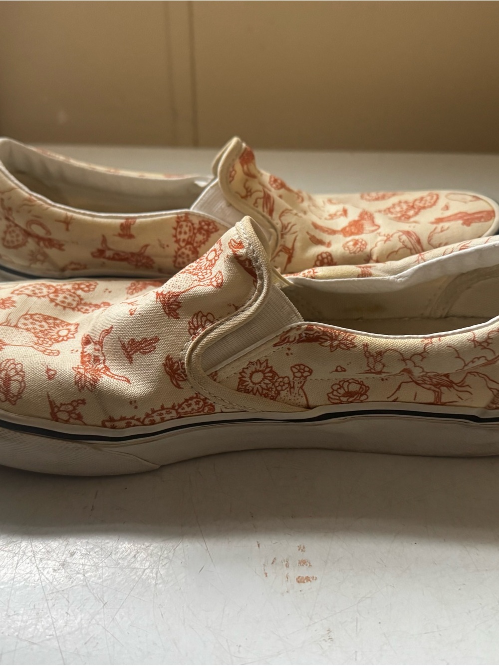 Vans Slip-On Sneakers in Cream with Orange Desert Print